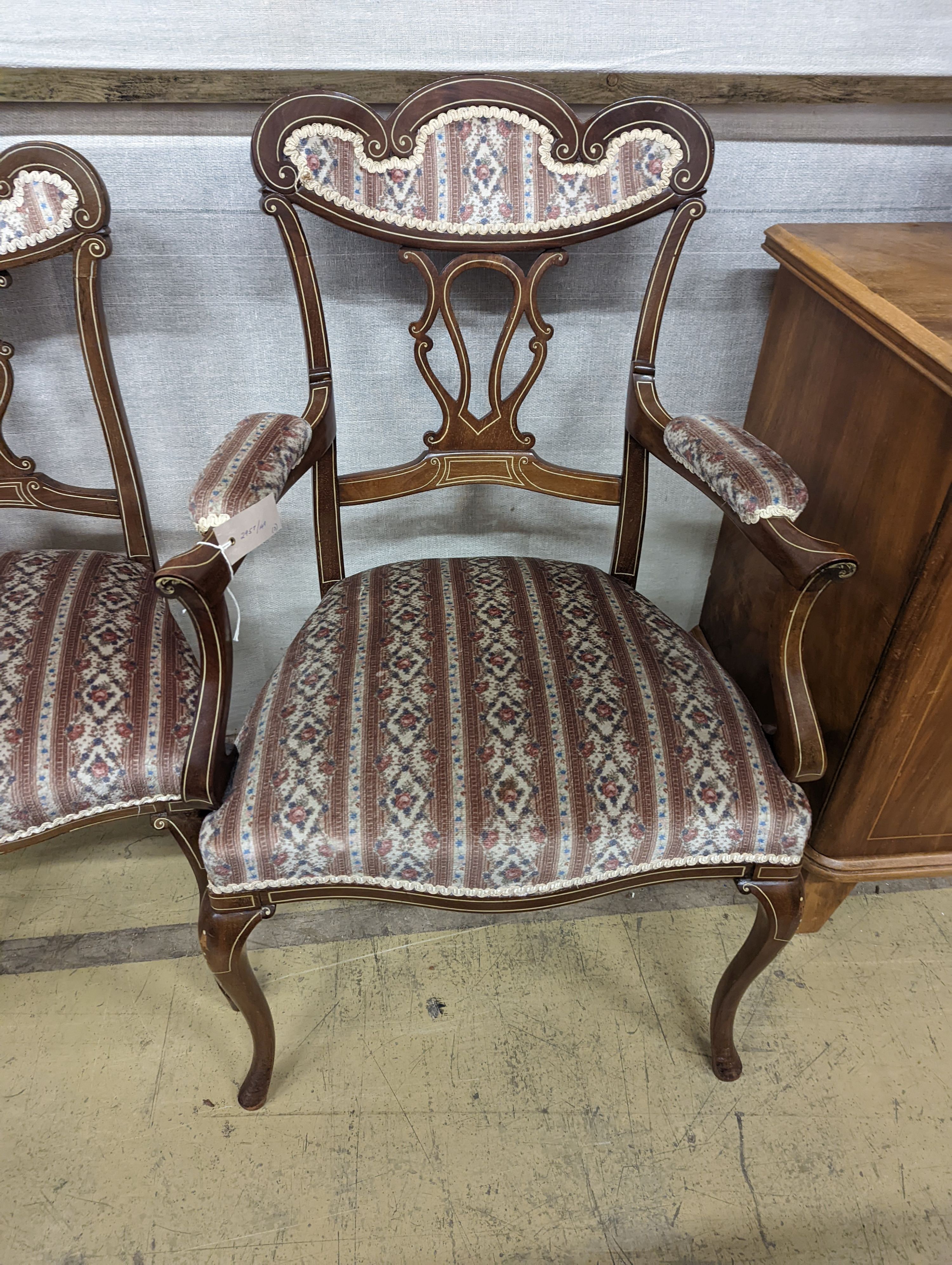 Three late Victorian bone inlaid mahogany chairs, two with arms, together with an Edwardian oval satinwood banded occasional table.